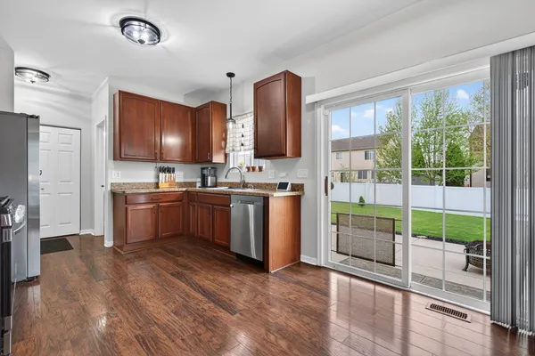 a kitchen with sink cabinets and refrigerator