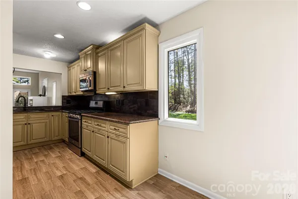a kitchen with a sink a refrigerator and a stove top oven