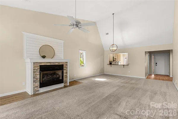 a view of empty room with fireplace and wooden floor