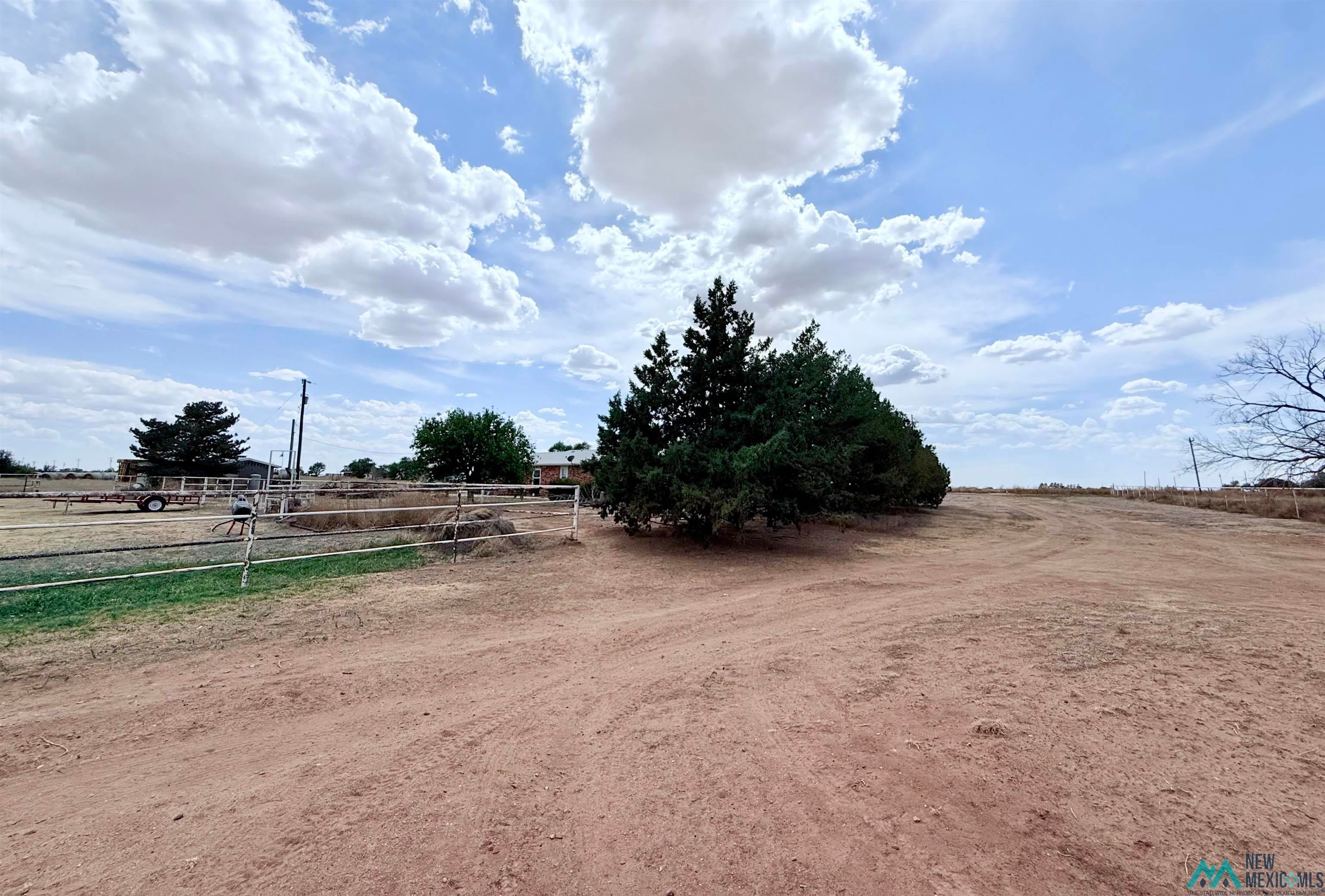 997 State Rte 108 Texico, NM 88135 - Photo 24 of 33 Expansive outdoor grounds featuring a dirt path, natural landscaping, and a fenced area