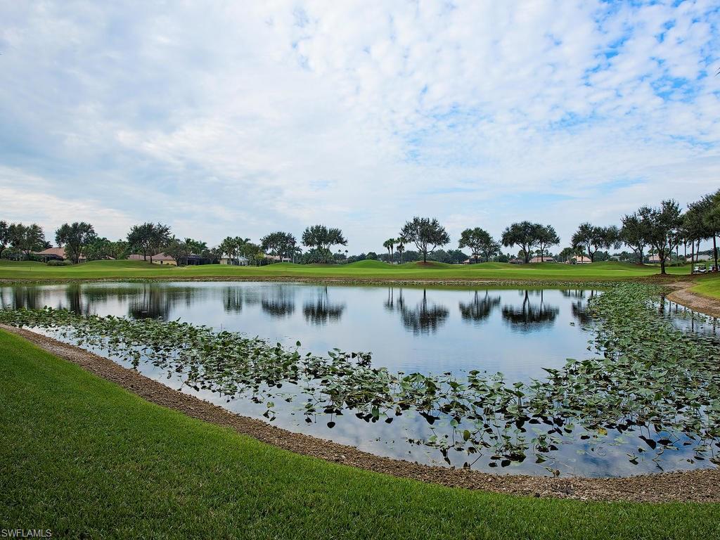3220 Hamlet Drive, Unit 2 Naples, FL 34105 - Photo 12 of 17 a view of a lake with a big yard and large trees