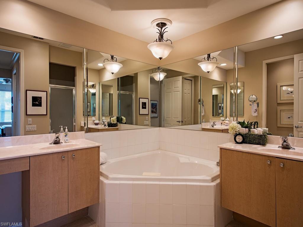 3220 Hamlet Drive, Unit 2 Naples, FL 34105 - Photo 10 of 17 a spacious bathroom with a tub sink and a mirror