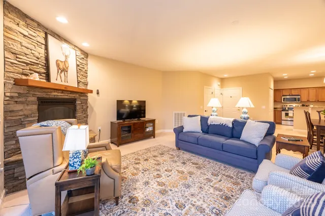 a living room with furniture fireplace and a flat screen tv