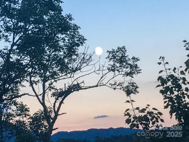 a view of a large building with mountains in the background