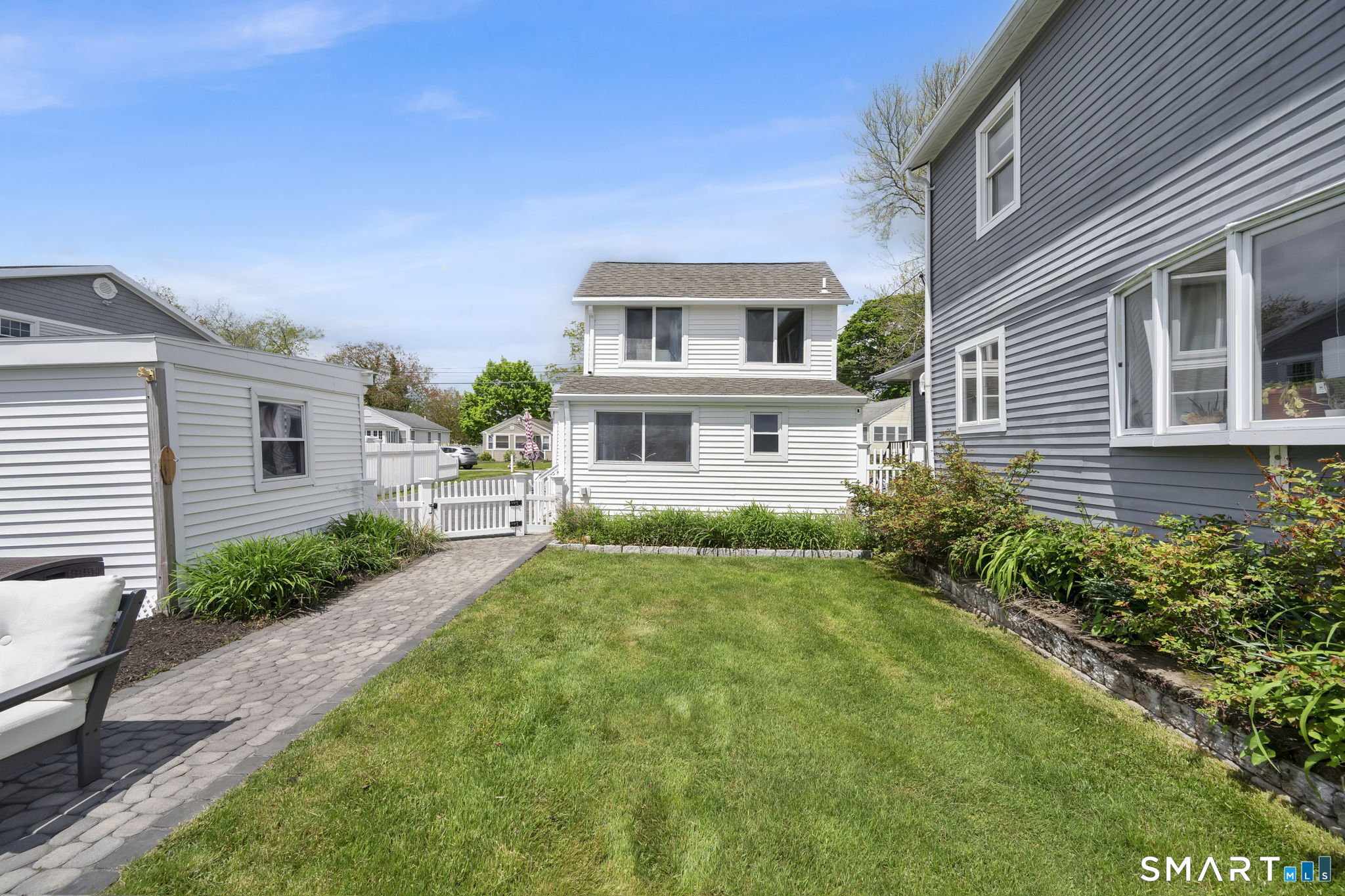 96 Chalker Beach Road Old Saybrook, CT 06475 - Photo 5 of 33 a front view of a house with garden