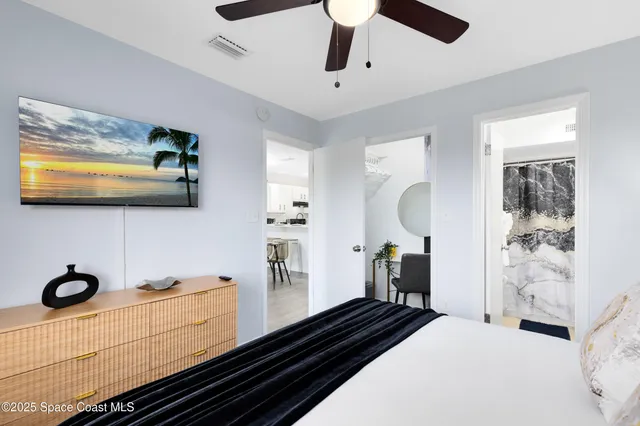 a bathroom with a sink toilet mirror vanity and shower