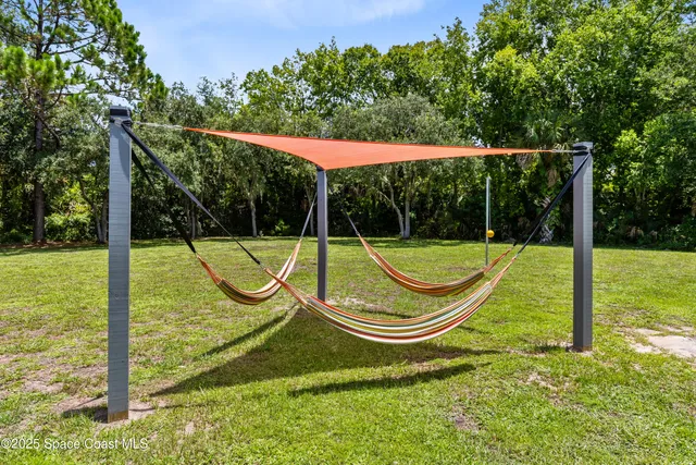 a view of a swimming pool with a potted plant and a sign on the wall