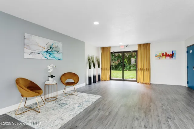 a view of an empty room with toys and wooden floor