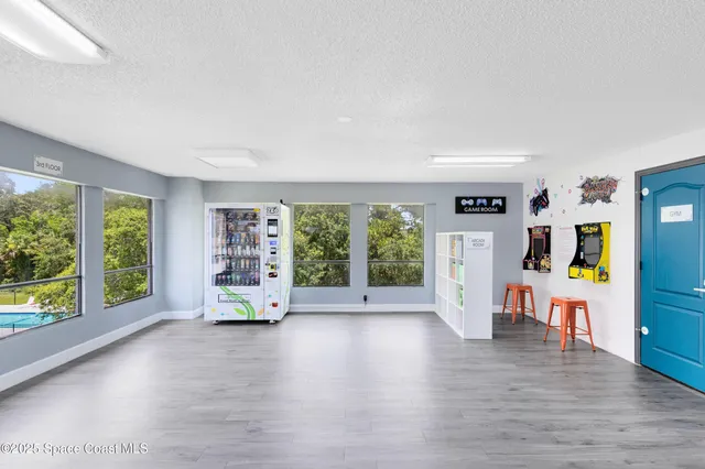 a view of a room with furniture and wooden floor