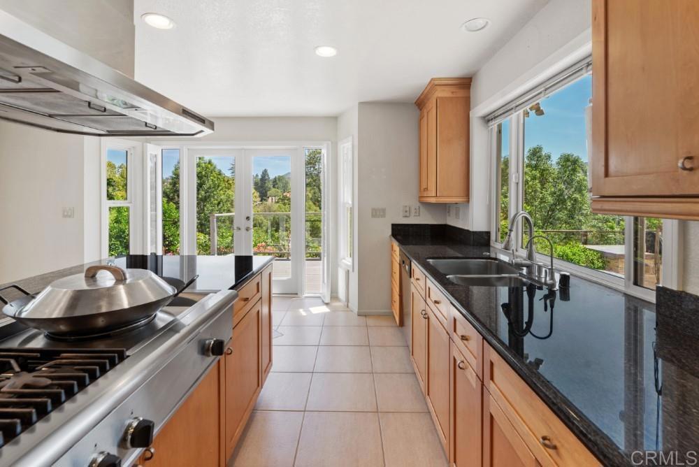 14040 Old Station Road Poway, CA 92064 - Photo 15 of 53 a kitchen with granite countertop a sink and a stove top oven