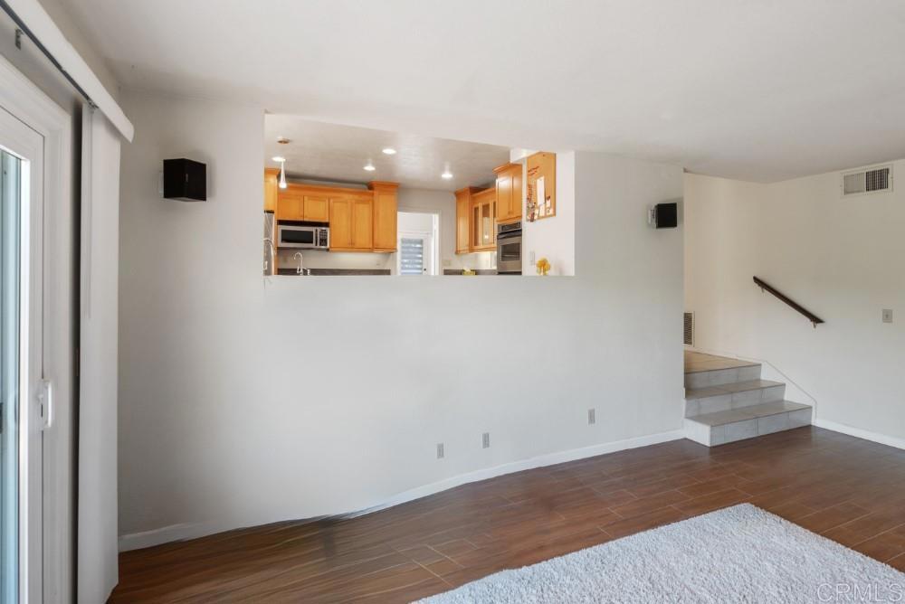 14040 Old Station Road Poway, CA 92064 - Photo 19 of 53 a view of an empty room with wooden floor and a window