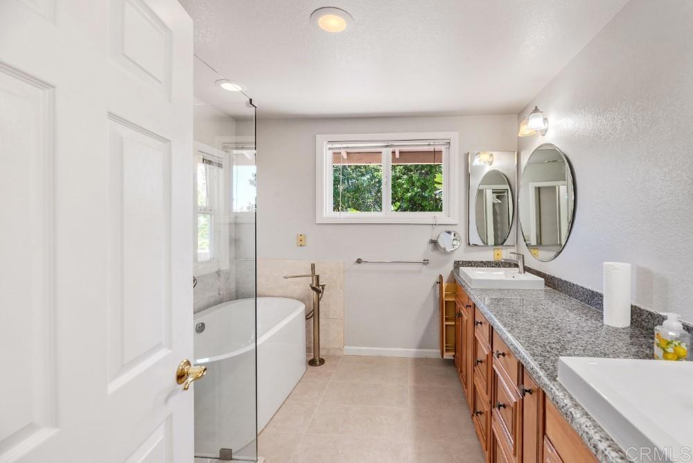 14040 Old Station Road Poway, CA 92064 - Photo 25 of 53 a bathroom with a granite countertop sink mirror bathtub and shower