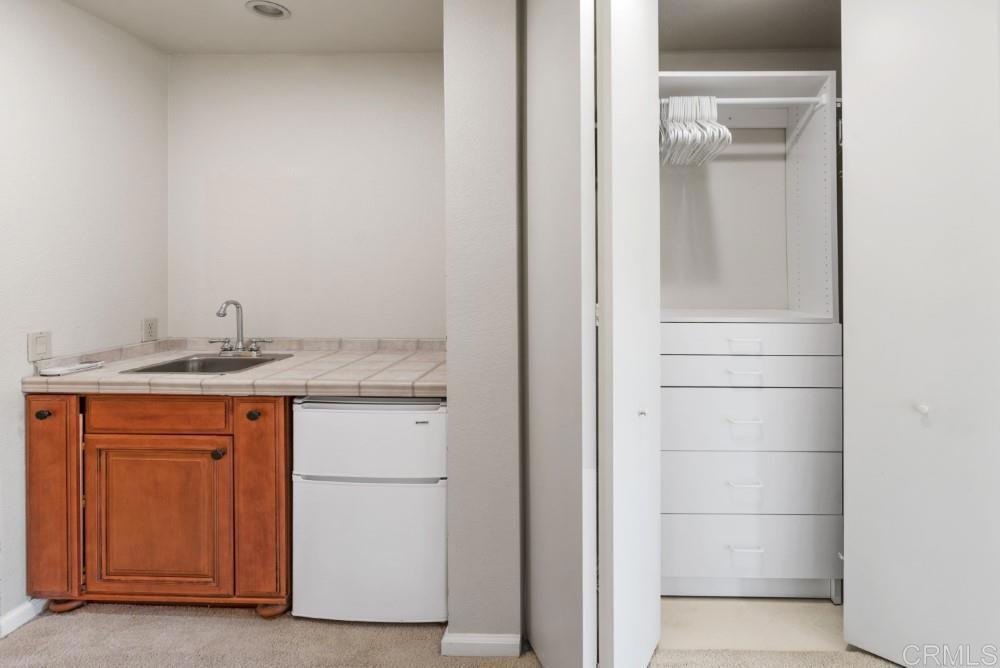 14040 Old Station Road Poway, CA 92064 - Photo 27 of 53 a bathroom with a granite countertop sink and a mirror