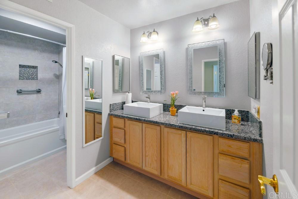14040 Old Station Road Poway, CA 92064 - Photo 35 of 53 a bathroom with a granite countertop sink and a mirror