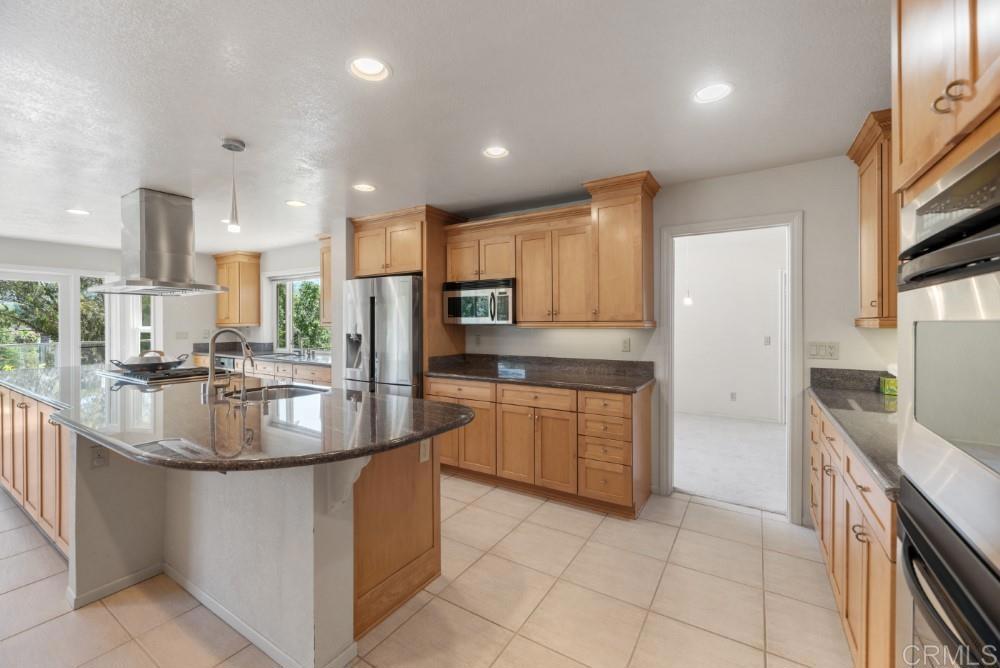 14040 Old Station Road Poway, CA 92064 - Photo 8 of 53 a kitchen with stainless steel appliances granite countertop a sink a stove and a refrigerator