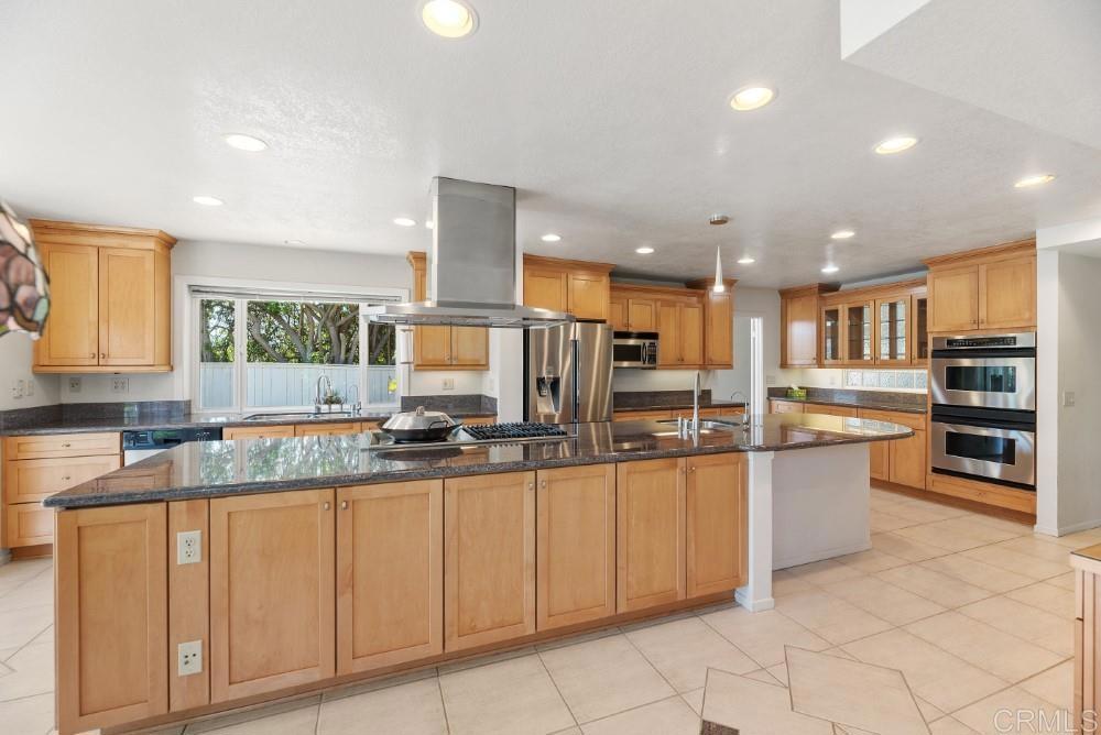 14040 Old Station Road Poway, CA 92064 - Photo 9 of 53 a kitchen with stainless steel appliances granite countertop a stove top oven a sink and dishwasher