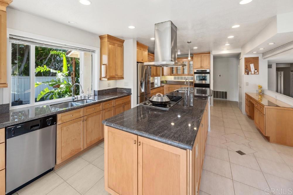 14040 Old Station Road Poway, CA 92064 - Photo 10 of 53 a kitchen with stainless steel appliances granite countertop a sink counter space cabinets and a large window