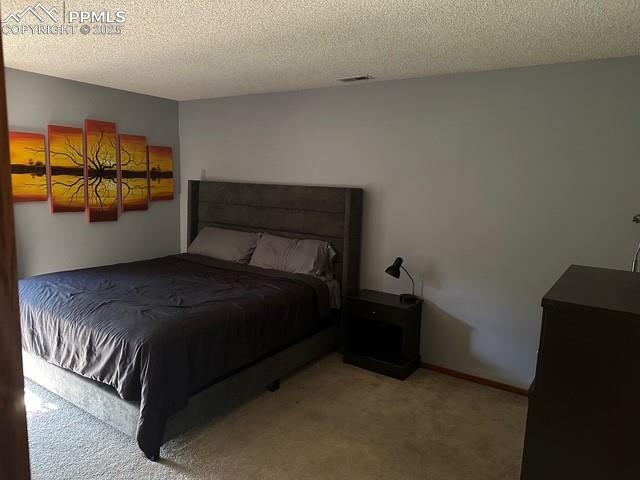 31 East Boulder Street Colorado Springs, CO 80903 - Photo 9 of 17 a bed sitting in a bedroom next to a window