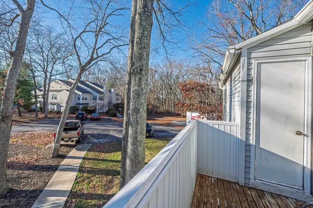 a view of a balcony with yard