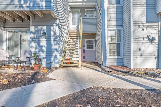 a backyard of a house with barbeque oven table and chairs