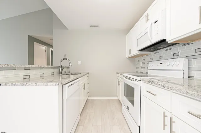 a kitchen with a sink stove and cabinets