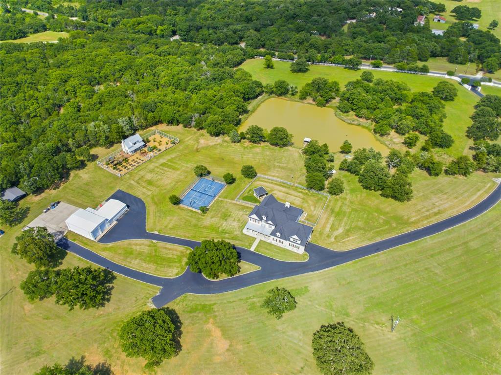 1073 Gordonville Road Gordonville, TX 76245 - Photo 1 of 38 Located 1 mile from Cedar Mills marina, this prime property includes a beautiful 5000 SF home with a large pond, paved roads with curbs, a pickle ball court, a greenhouse, and a 4 car garage which includes 2 RV garages.