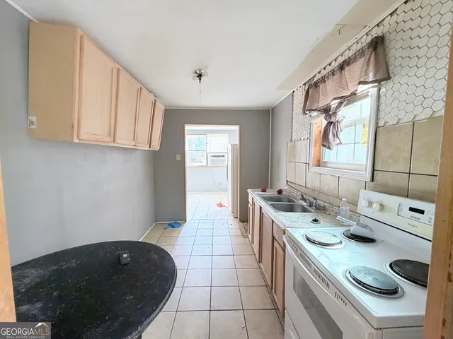 a kitchen with a sink stove and cabinets