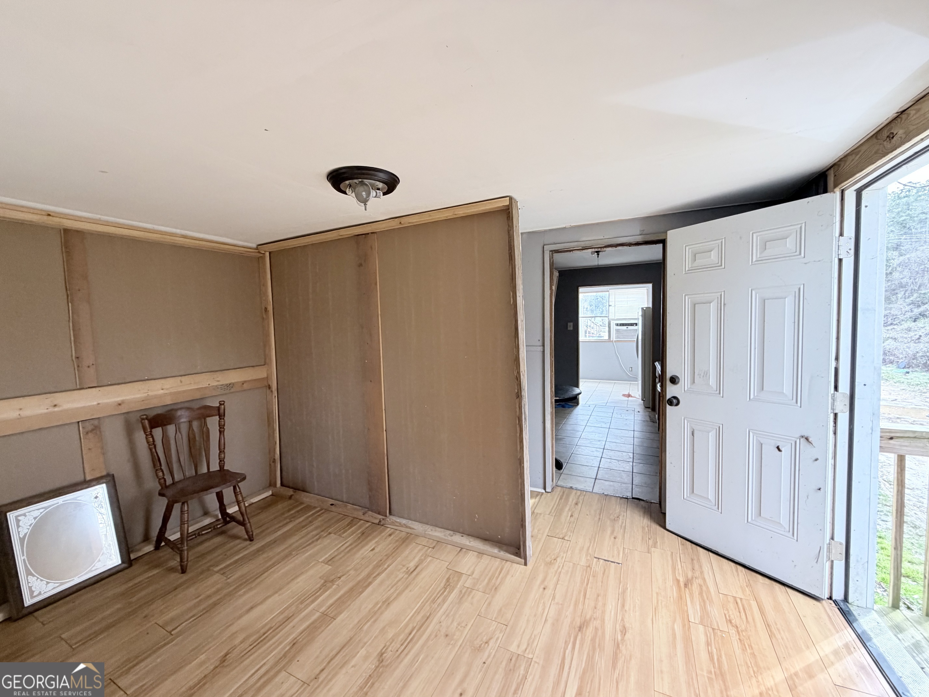 1037 Campbell St Extension Elberton, GA 30635 - Photo 6 of 7 a view of a hallway to a livingroom with wooden floor and furniture