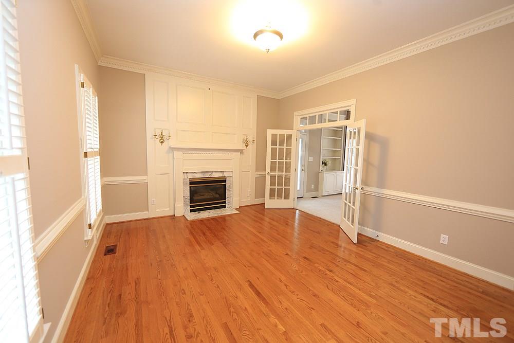 8617 Cold Springs Road Raleigh, NC 27615 - Photo 4 of 30 Use this room how it best fits your family. Would also make a great music room. This has one of three fireplaces.