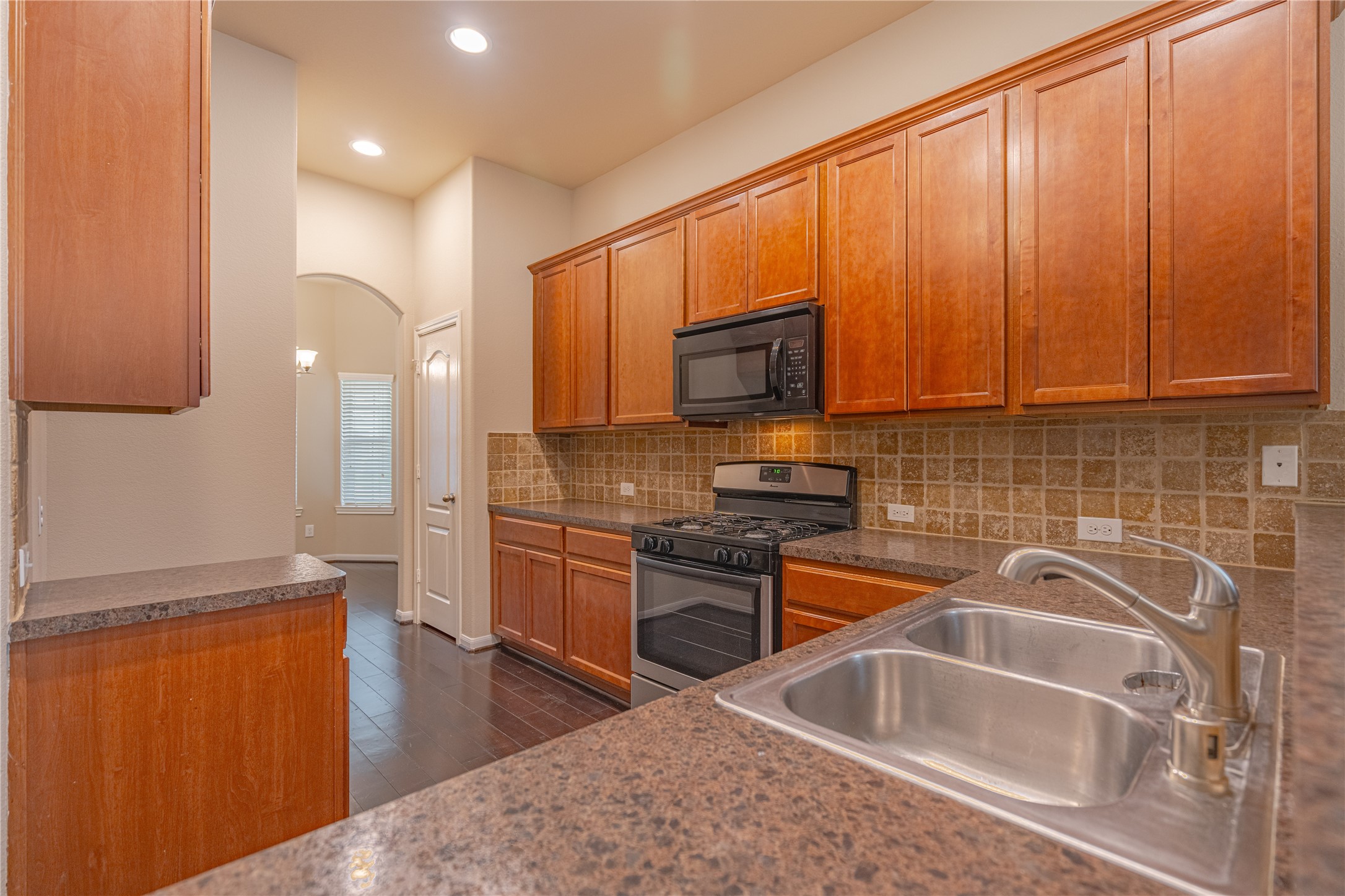 28514 Lockeridge Springs Drive Spring, TX 77386 - Photo 11 of 35 a kitchen with stainless steel appliances granite countertop a sink stove and refrigerator