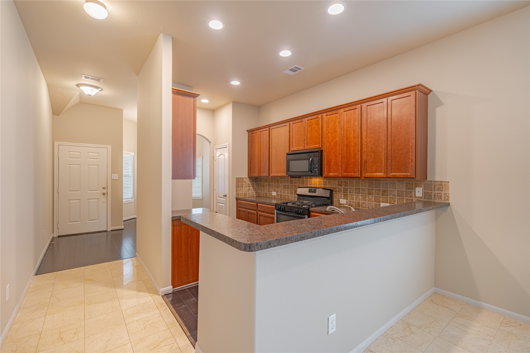 28514 Lockeridge Springs Drive Spring, TX 77386 - Photo 4 of 35 a kitchen with stainless steel appliances granite countertop a sink a stove and a refrigerator