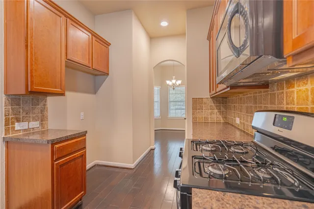 a kitchen with granite countertop a stove and a sink