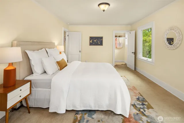 a spacious bedroom with a bed and a window