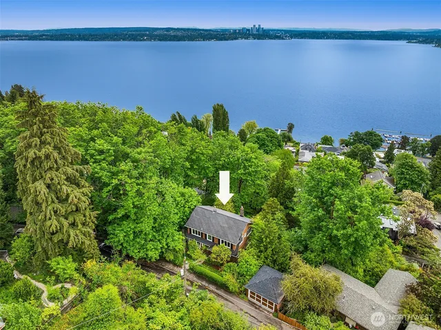 an aerial view of a house with a lake view