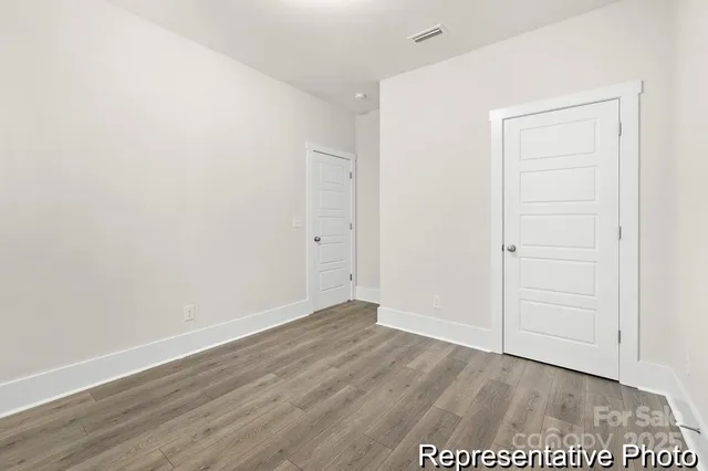 an empty room with wooden floor