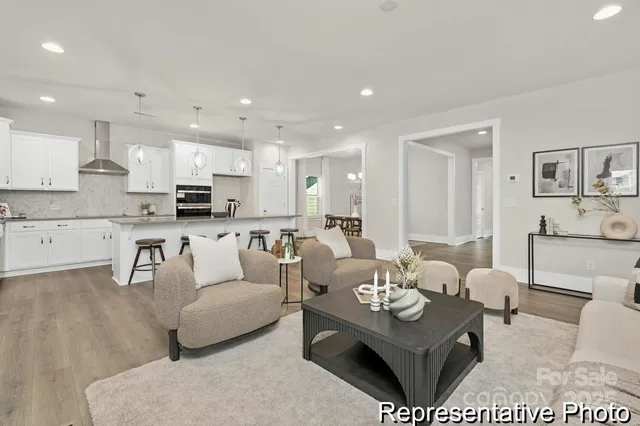 a living room with furniture kitchen and a table