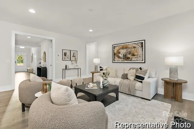 a living room with furniture potted plant and white walls
