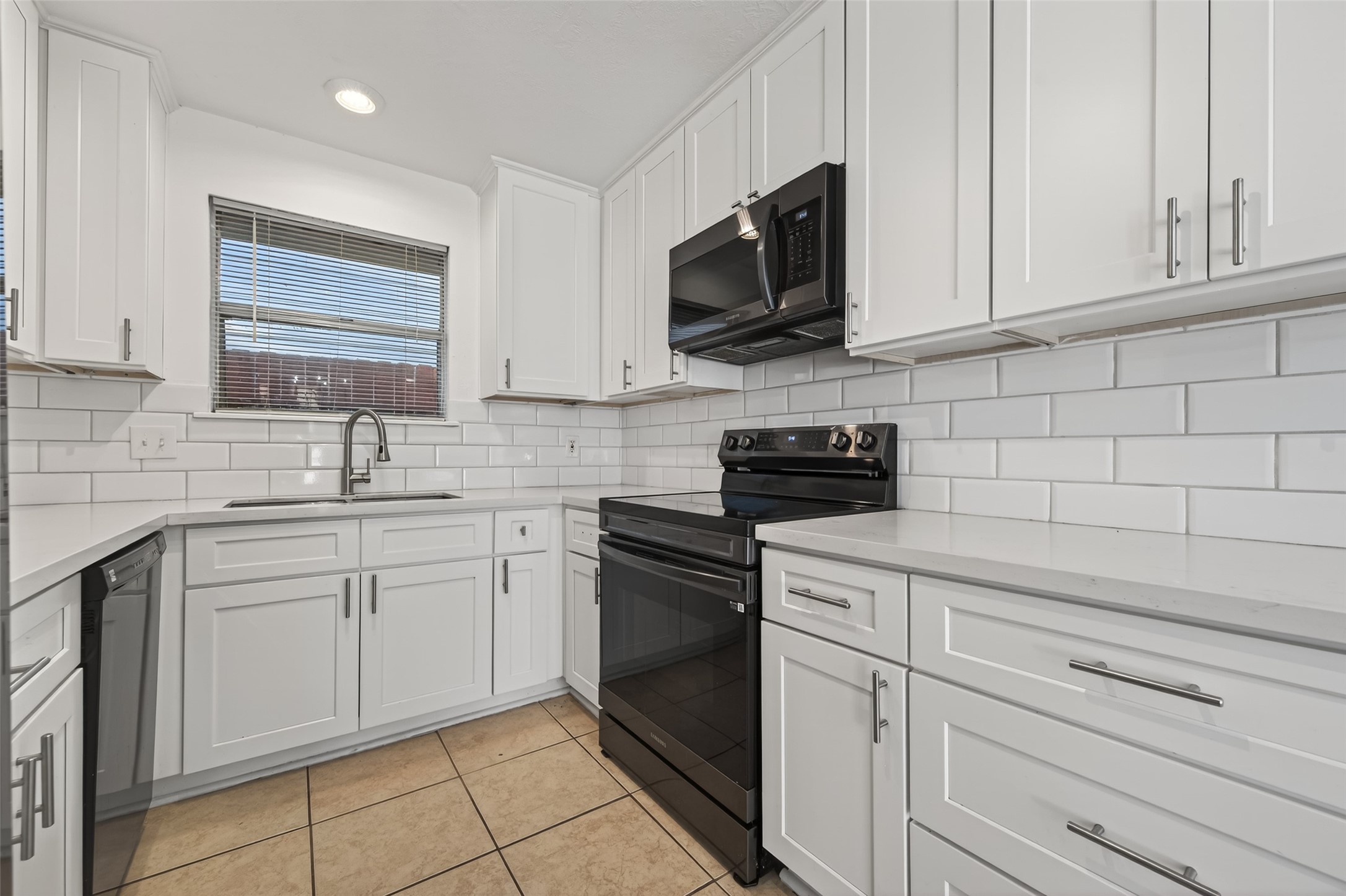2603 Shady Bayou Lane Spring, TX 77373 - Photo 14 of 43 a kitchen with white cabinets stainless steel appliances and a sink