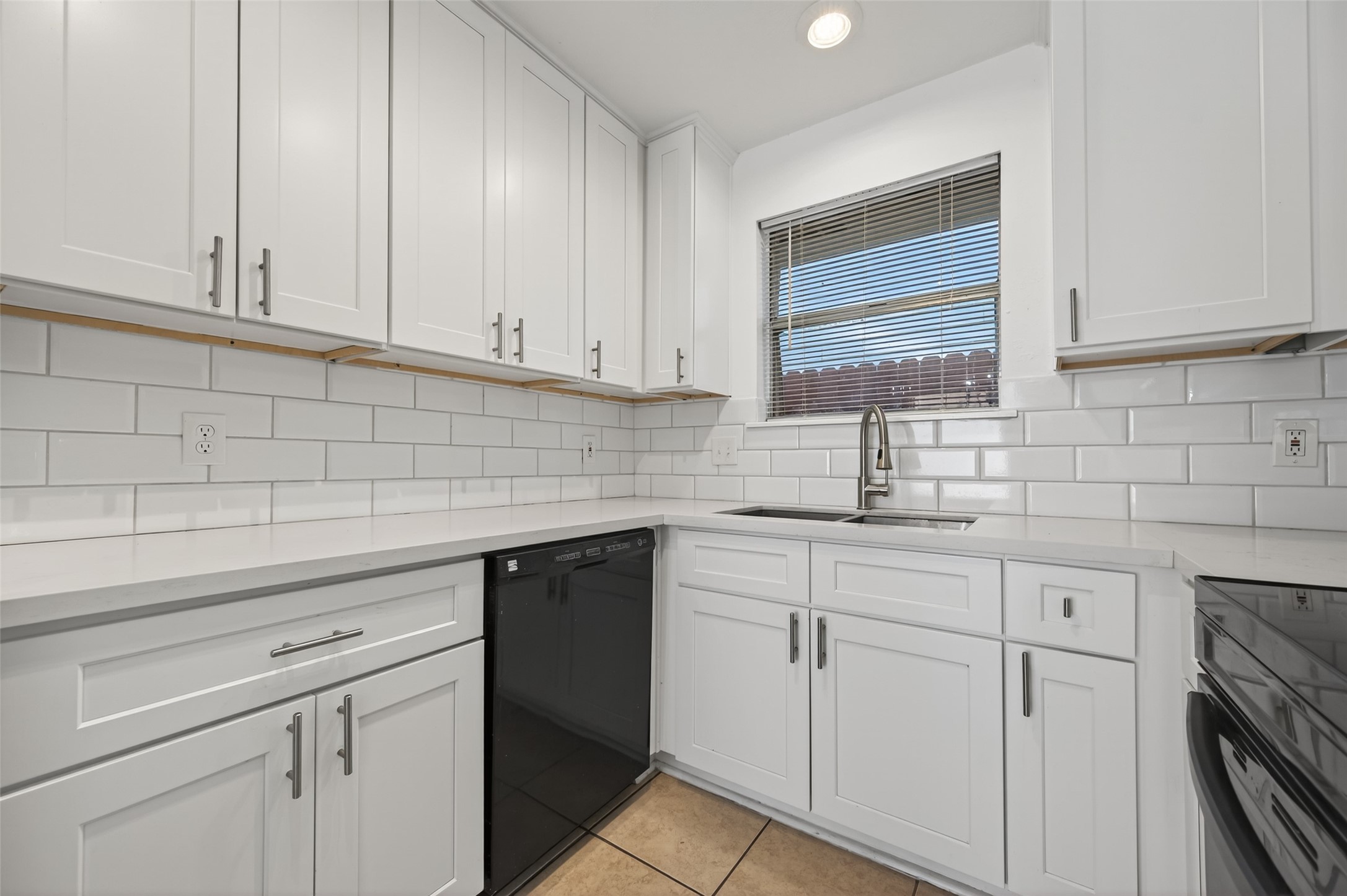 2603 Shady Bayou Lane Spring, TX 77373 - Photo 15 of 43 a kitchen with white cabinets and white appliances