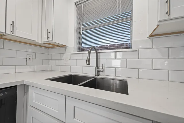 a kitchen with a sink and cabinets