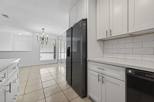 a kitchen with stainless steel appliances a refrigerator and cabinets