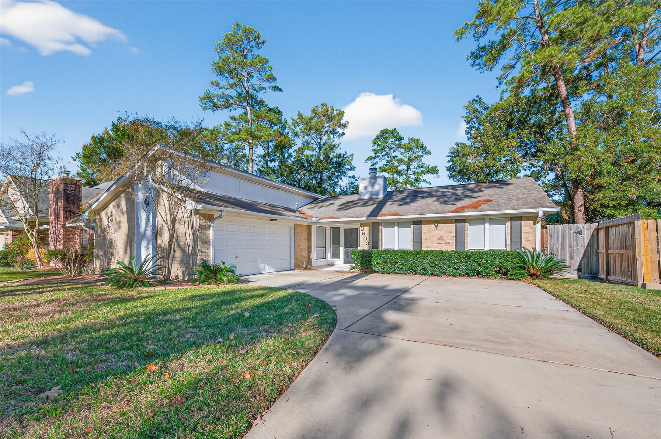 2603 Shady Bayou Lane Spring, TX 77373 - Photo 3 of 43 a front view of a house with a garden and trees