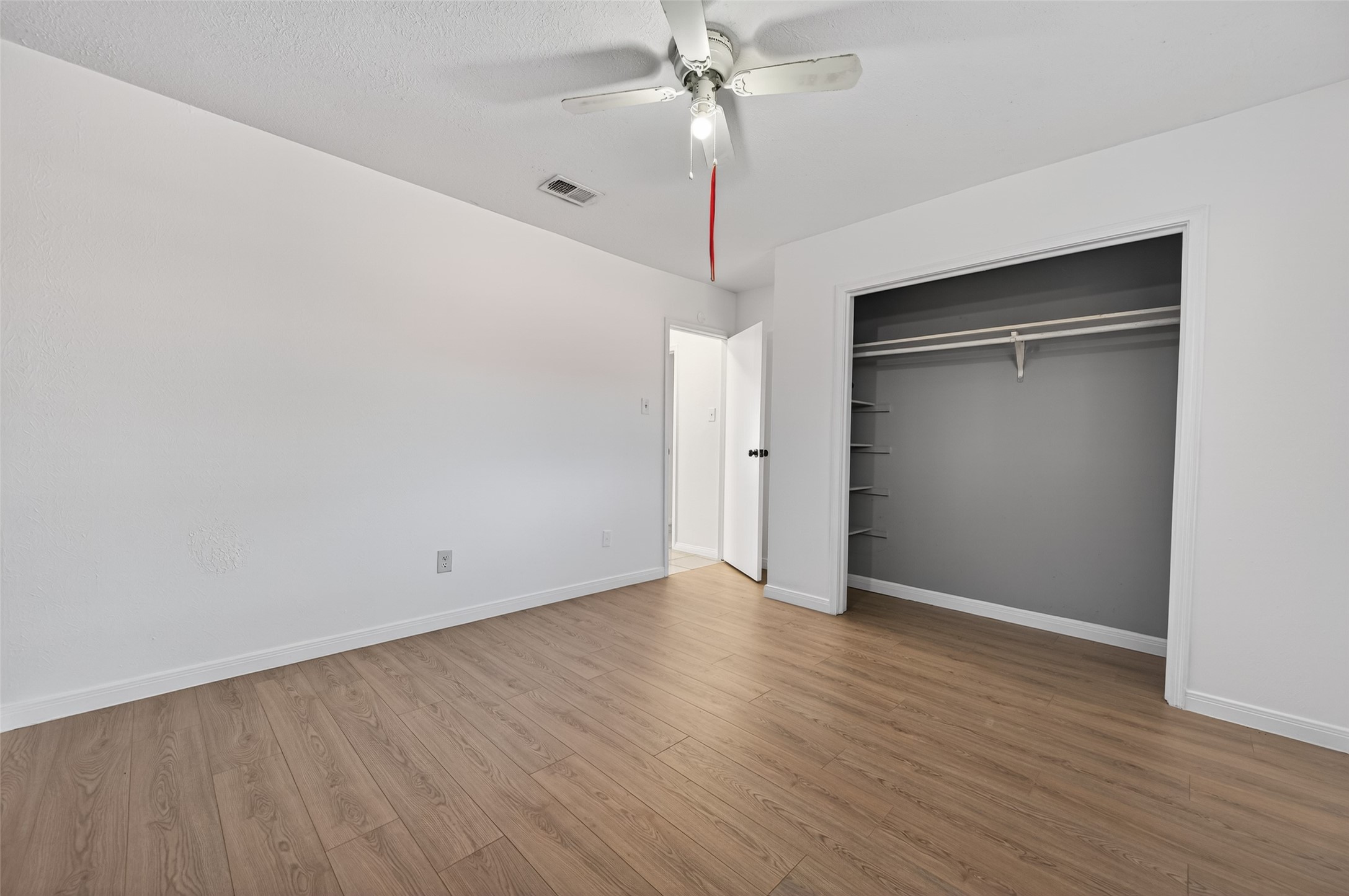 2603 Shady Bayou Lane Spring, TX 77373 - Photo 34 of 43 an empty room with wooden floor fan and windows