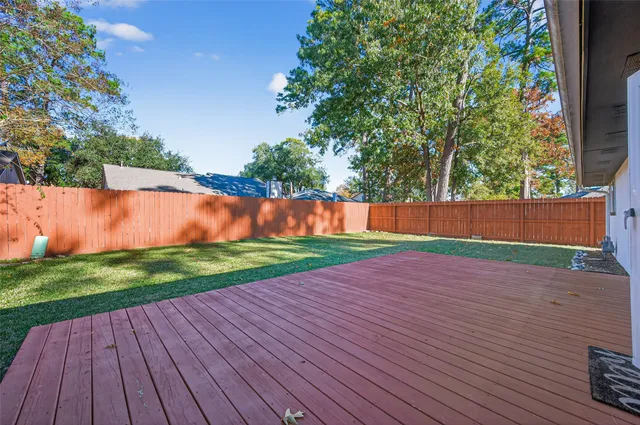 a view of yard with swimming pool and wooden fence