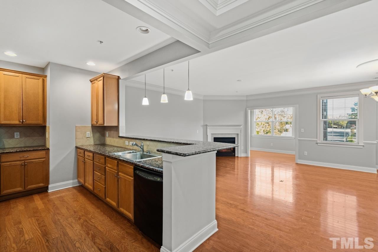 10421 Rosegate Court, Unit 201 Raleigh, NC 27617 - Photo 4 of 12 a kitchen with stainless steel appliances granite countertop a stove and a refrigerator