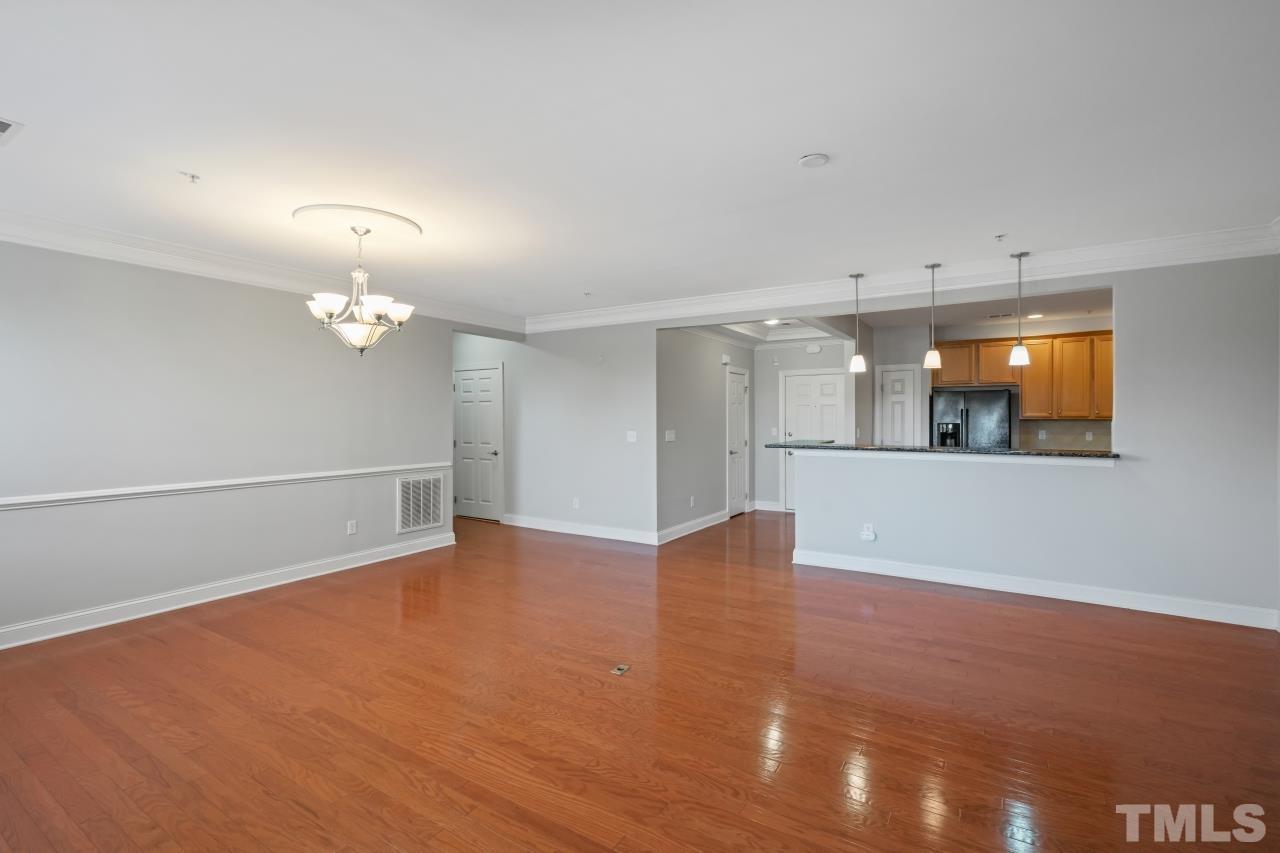 10421 Rosegate Court, Unit 201 Raleigh, NC 27617 - Photo 5 of 12 a view of an empty room with a kitchen