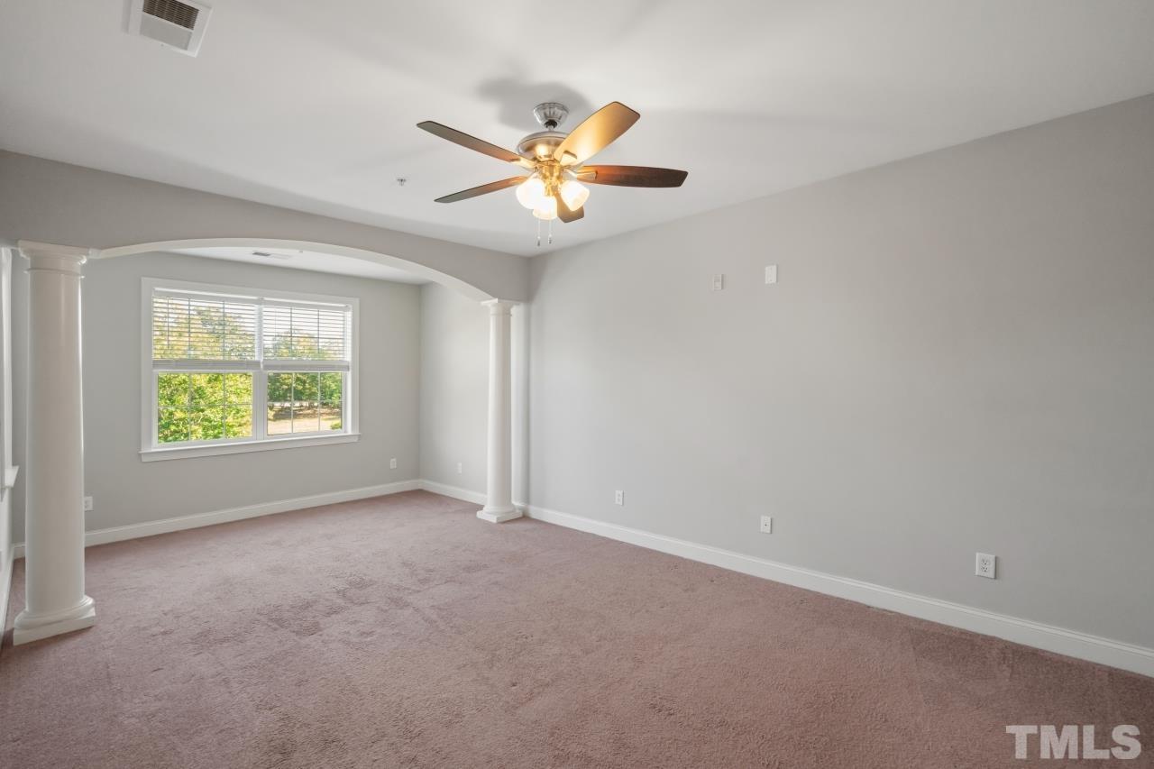 10421 Rosegate Court, Unit 201 Raleigh, NC 27617 - Photo 8 of 12 an empty room with windows and fan
