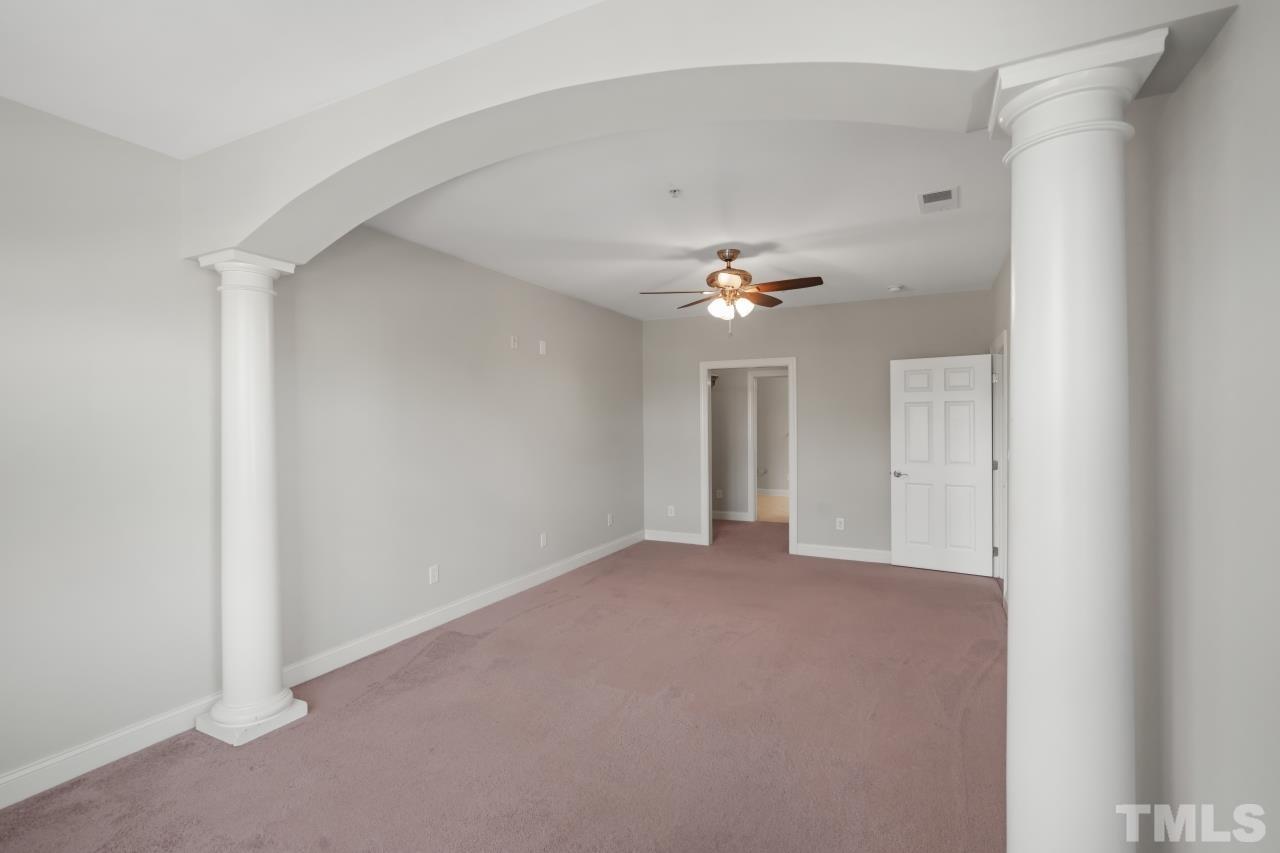 10421 Rosegate Court, Unit 201 Raleigh, NC 27617 - Photo 9 of 12 a view of an empty room with a chandelier fan