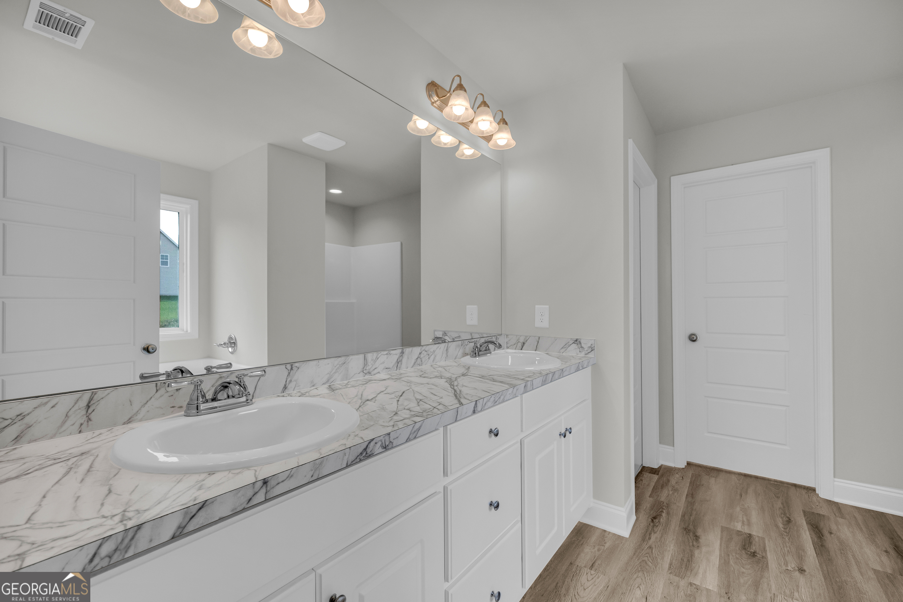 110 Sewell Road Lavonia, GA 30553 - Photo 17 of 73 a bathroom with a granite countertop sink a large mirror and vanity