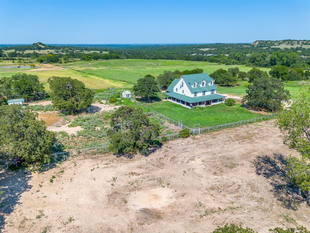 7726 West Highway 199 Springtown, TX 76082 - Photo 14 of 29 a large green field with lots of trees in the background
